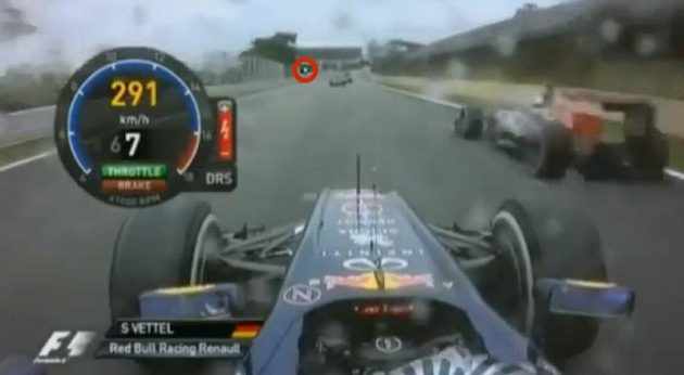 Sebastian Vettel předjíždí Jeana-Érika Vergneho, zelené světlo je daleko před oběma jezdci.