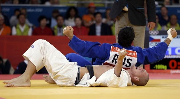 Český judista Lukáš Krpálek leží na tatami, raduje se jeho přemožitel Tagir Chajbulajev z Ruska