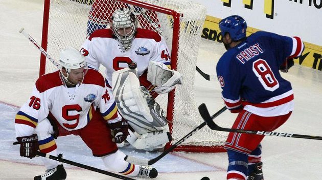 Brandon Prust z New York Rangers (vpravo) se snaží propasírovat puk přes bránícího sparťana Jaroslava Kasíka a brankáře Tomáše Pöpperleho.
