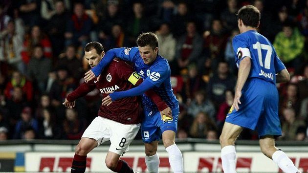 Sparťan Marek Matějovský (vlevo) si kryje míč před Lukášem Váchou z Liberce. Vpravo přihlíží Tomáš Janů.