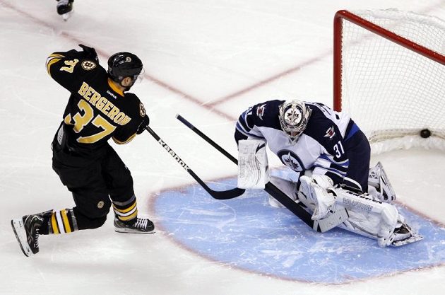 Útočník Bostonu Patrice Bergeron (vlevo) překonal v samostatných nájezdech brankáře Winnipegu Ondřeje Pavelce.