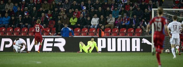 Aleksejs Višnakovs z Lotyšska (vlevo v pádu) překonává brankáře českého týmu Petra Čecha.