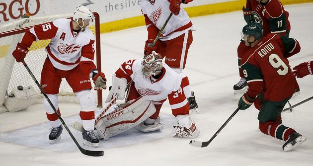 Útočník Minnesoty Mikko Koivu (č. 9) překonává brankáře Detroitu Petra Mrázka.