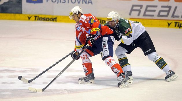 Karlovarský obránce Vladimír Sičák se snaží zastavit pardubického útočníka Lukáše Nahodila v předehrávce 24. kola Tipsport extraligy.