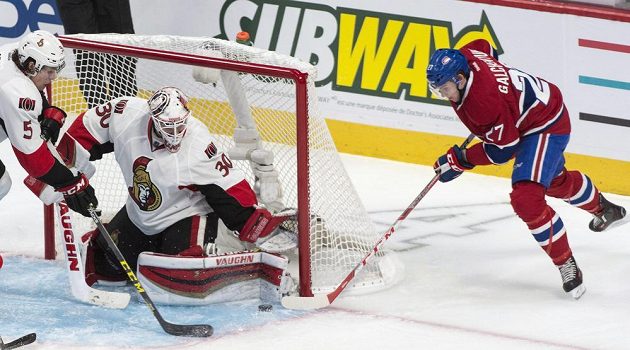 Andrew Hammond v bráně Ottawy čelí ataku montrealského Alexe Galchenyuka v úvodním utkání prvního kola play off NHL.