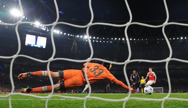 Brankář Arsenalu Petr Čech se natahuje po střele jednoho z borců Bayernu Mnichov.