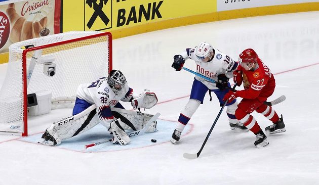 Ruský hokejový reprezentant Kirill Kaprizov se snaží prosadit v utkání mistrovství světa proti Norsku. Vše sleduje brankář Norska Henrik Haukeland, který je připravený zasáhnout.