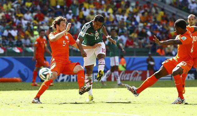 Giovani Dos Santos mezi Daleym Blindem (vlevo) a Georginiem Wijnaldumem střílí vedoucí gól Mexika v osmifinálovém duelu s Nizozemskem.