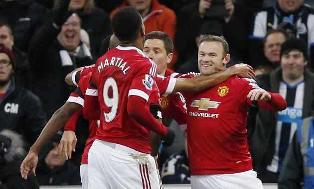 Wayne Rooney (vpravo) oslavuje se spoluhráči z Manchesteru United svoji trefu v utkání s Newcastlem.