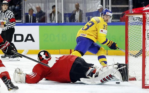 Švýcarský gólman Leonardo Genoni a Viktor Arvidsson ze Švédska. Tady gól nepadl.