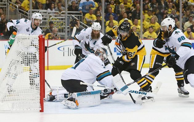 Gólman San Jose Martin Jones (31) zastavuje pokus Carla Hagelina (62) z Pittsburghu.
