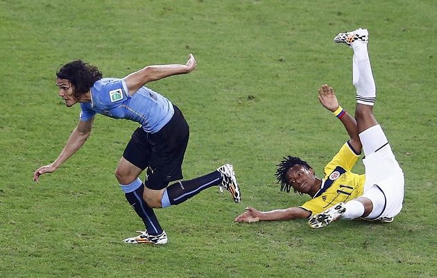 Na zemi skončil Juan Cuadrado (vpravo) po souboji s uruguayským střelcem Edinsonem Cavanim.