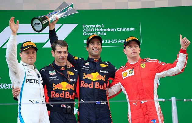 Vítěz čínské GP Daniel Ricciardo (druhý zprava) z Red Bullu oslavuje své vítězství s druhým Bottasem (vlevo) a třetím Räikkönenem (vpravo).