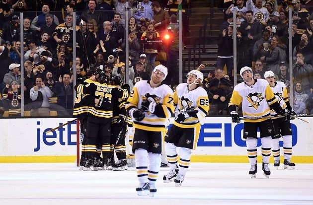 Bostonský uragán zničil v NHL hokejisty Pittsburghu Penguins. V pozadí slaví hráči Bruins Charlie McAvoy s českým centrem Davidem Krejčím. Tučňáci jen zklamaně odjíždějí na střídačku, naopak fanoušci byli u vytržení.