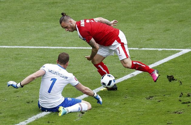 Útočník Rakouska Marko Arnautovič před brankářem Hannesem Halldorssonem z Islandu.
