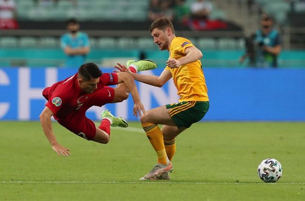 Turk Cengiz Under (left) and Ben Davies of Wales. 