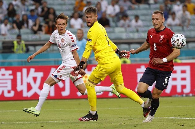 Danish footballer Mikkel Damsgaard shoots for the Czech goal in the EURO quarterfinals.  Goalkeeper Tomáš Vaclík just watches where the shot ends.