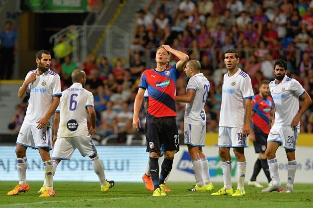 Zklamaný plzeňský obránce Václav Procházka (uprostřed). Kolem něj radující se hráči Maccabi Tel Aviv.