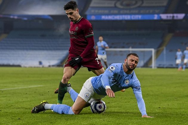 Fotbalista Manchesteru City Kyle Walker padá po zákroku Pedra Neta z Wolverhamptonu v utkání Premier League.