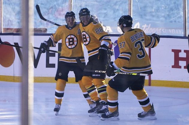 Radost v podání hokejistů Bostonu Bruins. David Pastrňák oslavuje svůj gól proti Philadelphii s parťáky Bradem Marchandem a Patricem Bergeronem.