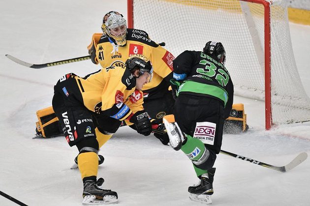 Litvínovský brankář Pavel Kantor se chystá zasáhnout proti zakončení Jakuba Orsavy z Mladé Boleslavi. Atakuje jej Marek Baránek z Litvínova. Vše v utkání 34. kola ELH.
