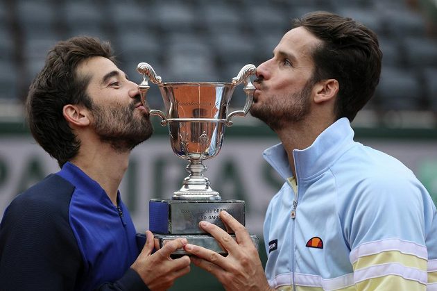 Španělé Feliciano López (vpravo) a Marc López s trofejí pro vítěze French Open.