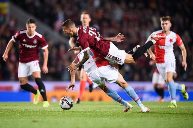 Klíčový moment derby. Lukáš Haraslín ze Sparty padá po faulou Aihama Ousoua ze Slavie, který bude vyloučen.