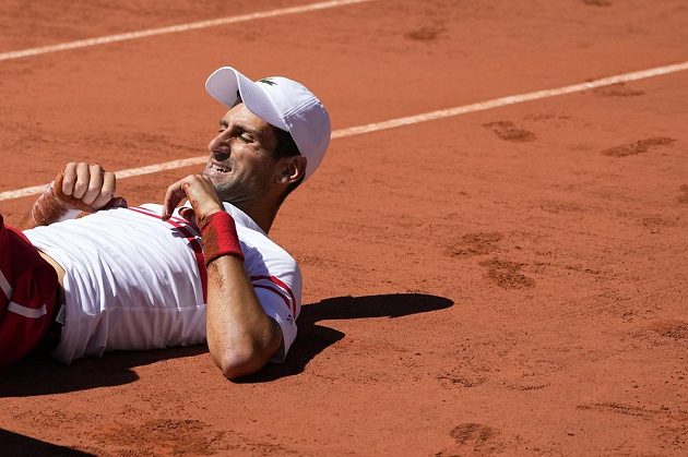 Serbian tennis player Novak Djokovic is lying on the clay during the French Open final, when he fell while finishing his shorts.