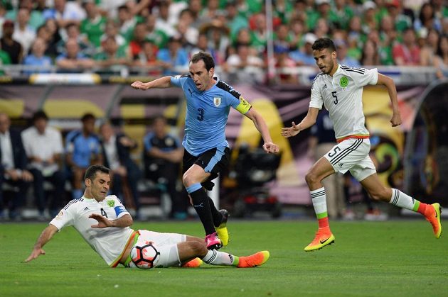 Kapitán Uruguaye Diego Godín (3) a mexičtí obránci Diego Reyes (5) s Rafaelem Márquezem.