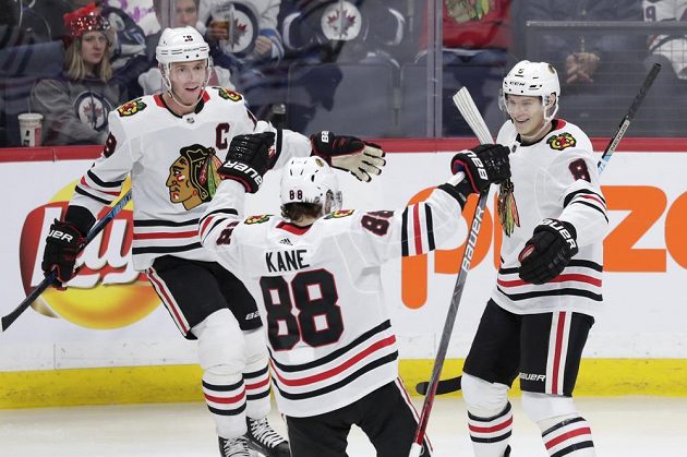 Jonathan Toews, Patrick Kane a Dominik Kubalík (vlevo) se radují z branky