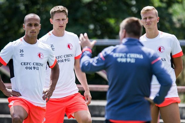 Letní posila Slavie Praha Gino van Kessel (vlevo), útočník Milan Škoda a záložník Antonín Barák (vpravo) naslouchají kouči Dušanu Uhrinovi během tréninku.