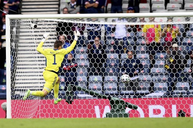 Unfortunate Scottish goalkeeper David Marshall tries in vain to stop the ball heading into the net during the EURO match.