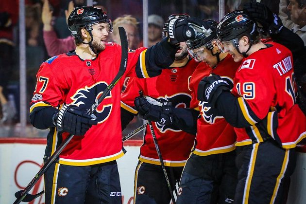 Český útočník Michael Frolík (vlevo) se sice radoval z gólu Calgary Flames v utkání se San Jose Sharks, nakonec ale Plameny prohrály 2:3.