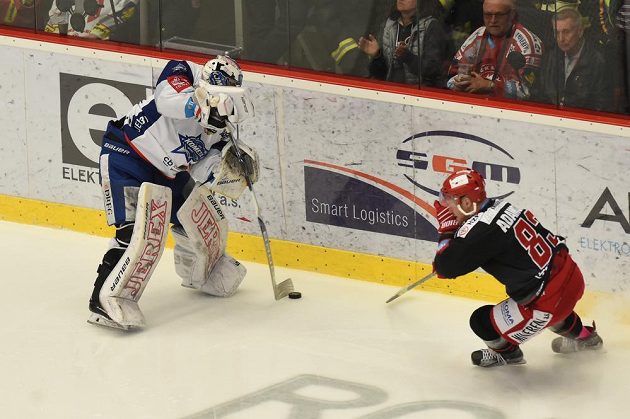 Brankář Komety Brno Marek Čiliak rozehrává puk před dotírajícím Martinem Adamským z Třince ve finále extraligy.