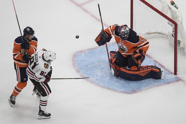 Gólman Edmontonu Oilers Mike Smith (41) tentokrát stihl zasáhnout po zakončení Drakea Caggiuly (91) z Chicaga.