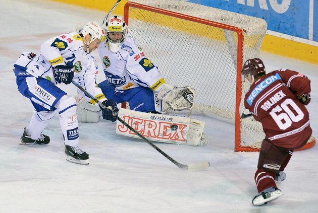 Sparťanský forvard Tomáš Rolinek (vpravo) se snaží dopravit puk za záda brněnského brankáře Marka Čiliaka. Vlevo přihlíží obránce Komety Tomáš Malec.