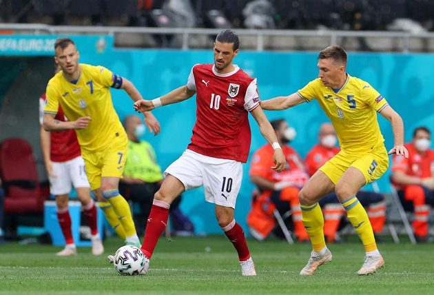 Austrian Florian Grillitsch is battling a pair of Ukrainian footballers Andriy Jarmolenko (left) and Serhiy Sydorchuk.