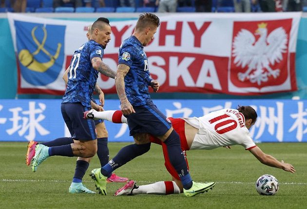 Polish footballer Grzegorz Krychowiak falls to the ground after a duel with Slovak Juraj Kucka, Slovak Marek Hamšík also took part in the duel for the ball in the EURO match.