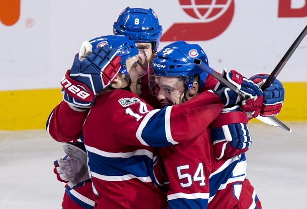 Český útočník Tomáš Plekanec z Montrealu Canadiens slaví se spoluhráči vítěznou trefu v prodloužení utkání s New Jersey Devils.