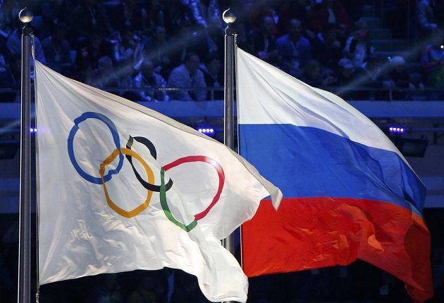 Ruská národní vlajka (vpravo) a vlajka olympijská vlály při slavnostním ceremoniálu zakončení her v Soči.