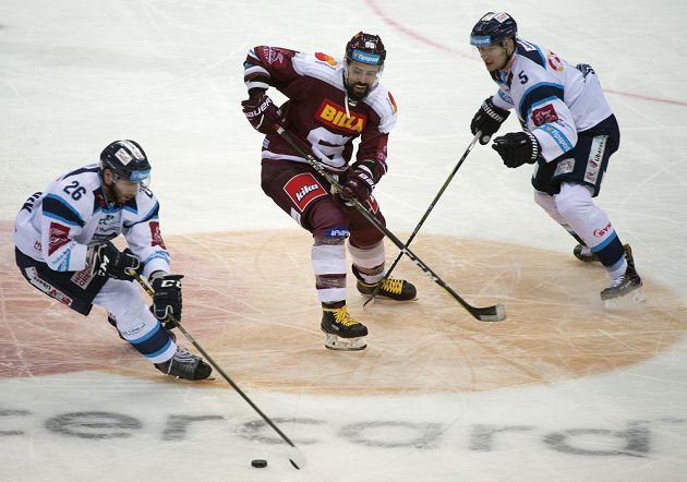 Sparťanský hrdina Richard Jarůšek se blýskl v duelu s Libercem hattrickem. Na snímku sleduje Petra Jelínka s kotoučem na holi. Atatkovat se sparťana chystá Ladislav Šmíd (vpravo).