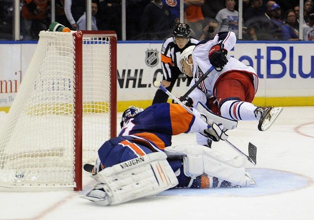 Columbus Blue Jackets' Cam Atkinson (13) shoots the puck past New York Islanders goalie Evgeni Nabokov (20) during an NHL hockey game on Saturday, Oct. 5, 2013, in Uniondale, N.Y. (AP Photo/Kathy Kmonicek)