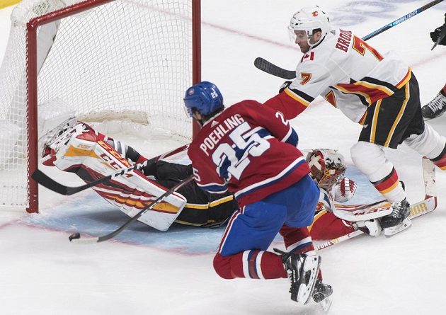 Ryan Poehling z Montrealu Canadiens překonává Davida Ritticha v brance Calgary Flames.