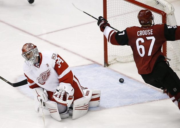 Lawson Crouse (67) z týmu Arizona Coyotes překonal brankáře Detroitu Red Wings Petra Mrázka.