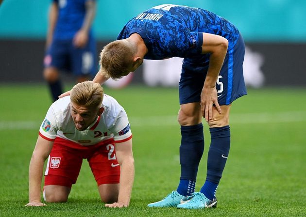 Slovak football representative Tomáš Hubočan apologizes to Polish opponent Kamil Jozwiak during the EURO match.