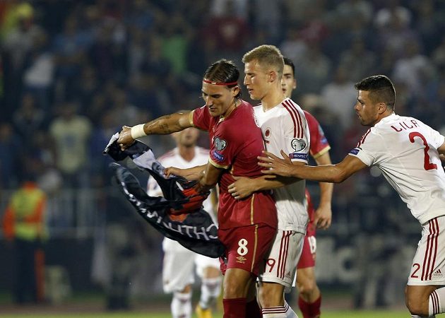 Srb Nemanja Gudelj (vlevo) drží albánskou vlajku. Za ním stojí hráč Slavie Bekim Balaj z Albánie.