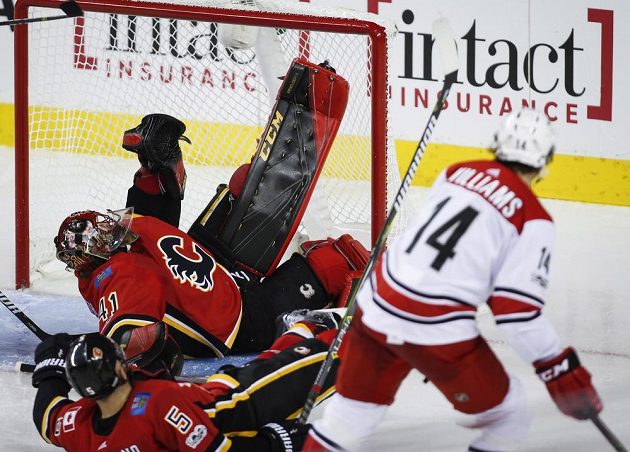 Justin Williams střílí vítězný gól Caroliny v souboji s Calgary, brankář Mike Smith už zasáhnout nestačil.