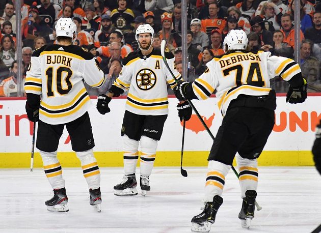 Hokejový útočník Bostonu David Krejčí (46) se spoluhráči gól vstřelený na ledě Philadelphie.