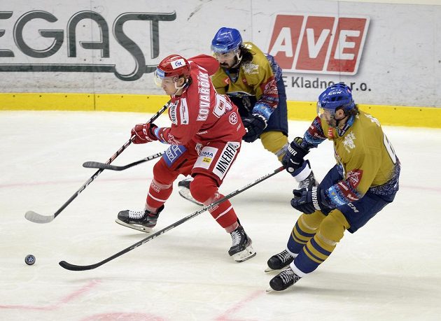 Zleva Michal Kovarčík z Třince, Ladislav Zikmund a Jaromír Jágr bojují o puk v utkání 14. kola hokejové extraligy