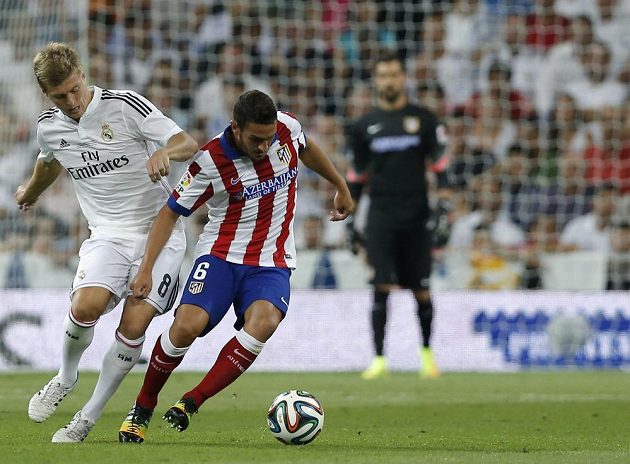 Záložník Realu Madrid Toni Kroos (vlevo) se snaží vypíchnout míč Kokemu z Atlétika.